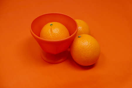 Orange monochrome image of fruit on color background for health food.の写真素材