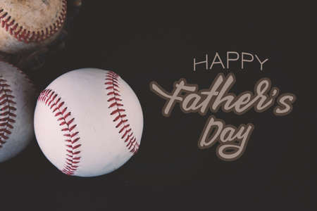 Baseball balls on black background with Father's Day text for sports banner celebration of the holiday.の写真素材