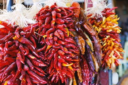 Peppers hanging at public marketの写真素材