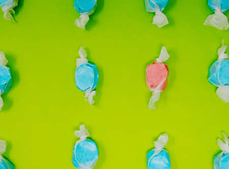 Taffy candy flat lay on green background, in rows.の写真素材