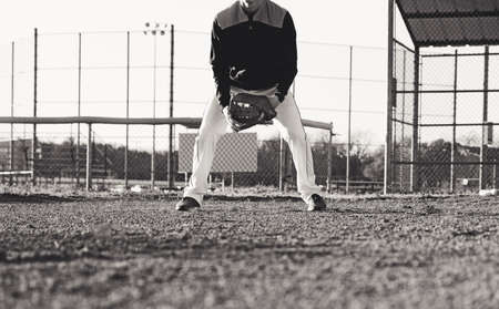 Baseball player on field for practice with copy space on dirt, vintage sports styleの写真素材