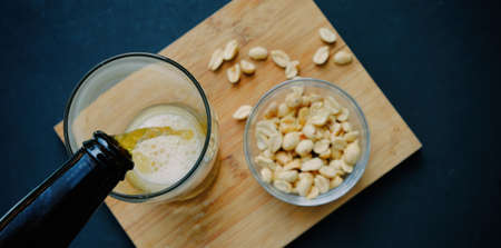 Flat lay Father's Day concept of beer pour for adult with peanuts.の写真素材