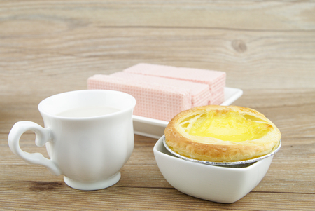 Egg tart and snack on the wooden tableの写真素材