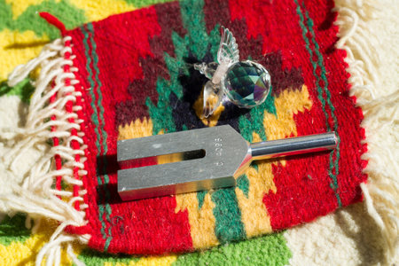 tuning fork and crystal on table.