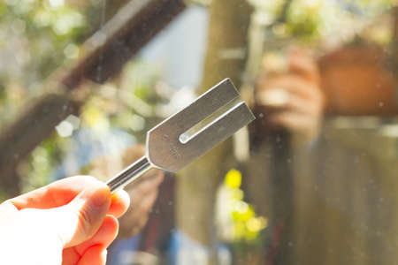 tuning fork and crystal on table.の写真素材