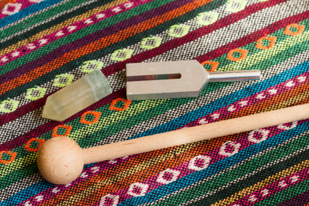 tuning fork and crystal on table.