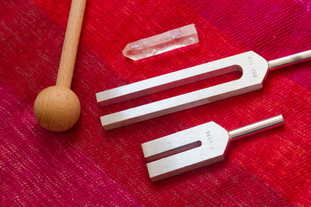tuning fork and crystal on table.