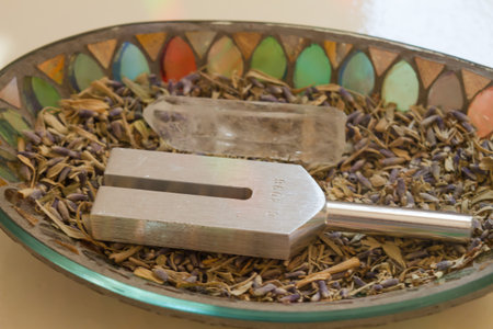 tuning fork and crystal on table.