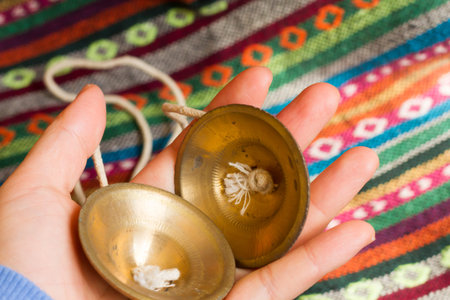 Tibetan bell tingsha on hand.