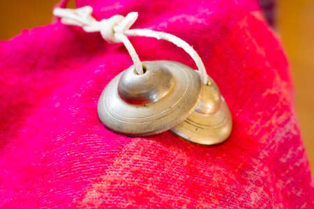 Tibetan bell tingsha on table.の写真素材