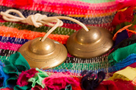 Tibetan bell tingsha on table.の写真素材