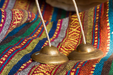 Tibetan bell tingsha on table.の写真素材