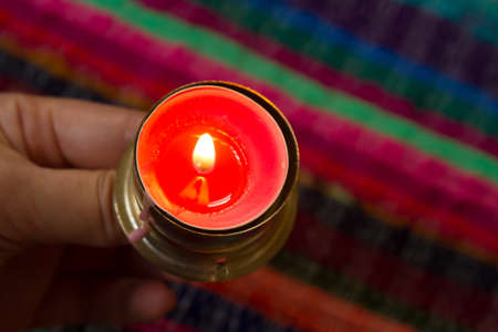 Gold candle on a pink table.の写真素材