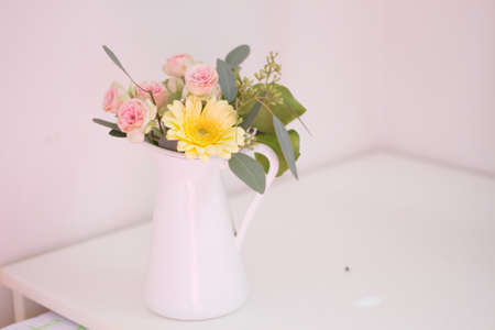 flower arrangement in white enamel .の写真素材