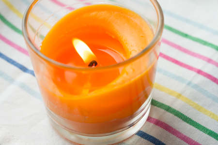 pink candle and light bule candle on a table .の写真素材