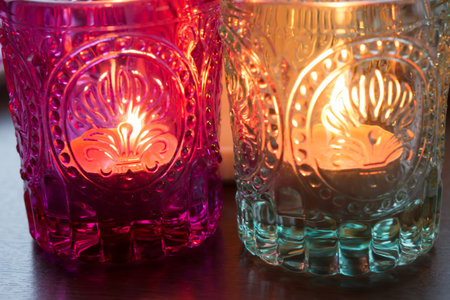 pink candle and light bule candle on a table .の写真素材