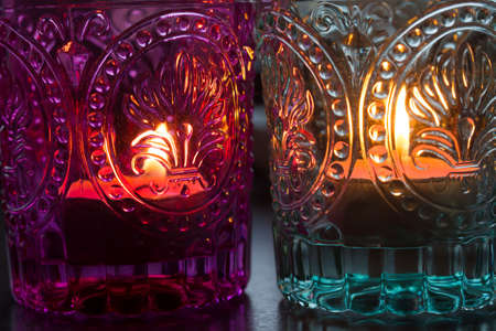 pink candle and light blue candle on a table .の写真素材