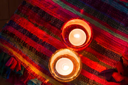 pink candle and light blue candle on a table .の写真素材