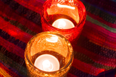 pink candle and light blue candle on a table .の写真素材