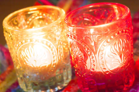 pink candle and light blue candle on a table .の写真素材