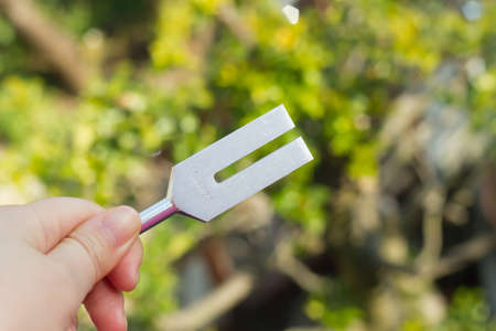 tuning fork and crystal on table .の写真素材