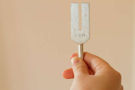 tuning fork and crystal on table .の写真素材
