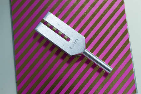 tuning fork and crystal on table .の写真素材