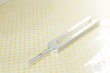 tuning fork and crystal on table .の写真素材