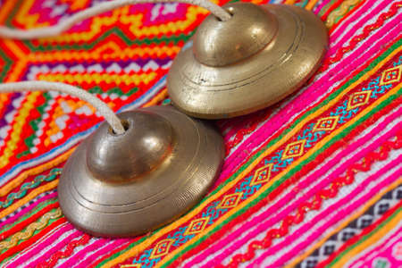 Tibetan bell tingsha on cloth.の写真素材