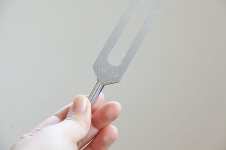 Hand holding a tuning fork