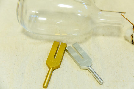 A set of screwdrivers and a glass bottle on a wooden table