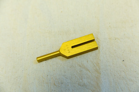 golden key on a wooden board, close-up of photo