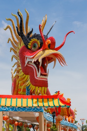 Dragon statue with beautiful clouds and blue sky as background の写真素材