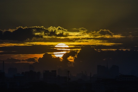 Sunset in the city, with a the shiny black with clouds building in Bangkok, Thailand.の写真素材