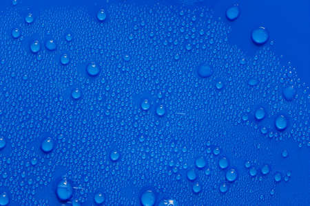 Water drops on a backgrounds of blue plasticの写真素材