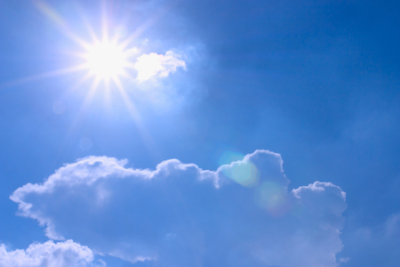 Sun above the clouds on a blue background の写真素材