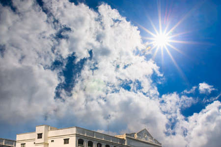 Beautiful blue sky with sun and clouds  Building solar radiation overの写真素材