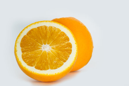 Orange fruit sliced ??in half on a white backgroundの写真素材
