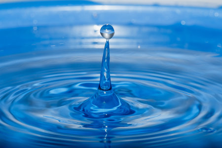 Water droplets  higher on the surface of the blue.