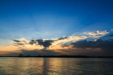 Sunlight radiate above the clouds  reflection  in the riverの写真素材