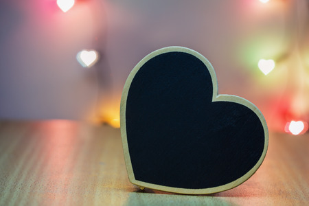 Black wood heart with background lighting.の写真素材