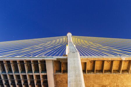 A bridge structure Cable cross the river at night.の写真素材