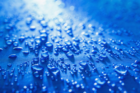 Rain Water droplets on blue fiber waterproof fabricの写真素材