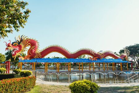 Symbol ,Red  dragon statue in parks in during the summerの写真素材