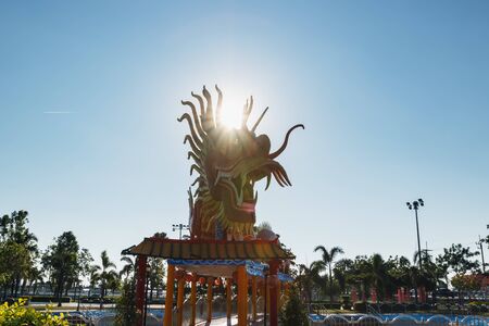 Symbol ,Red  dragon statue in parks with sun rayのeditorial素材