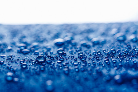 Rain Water droplets on blue fiber waterproof fabricの写真素材