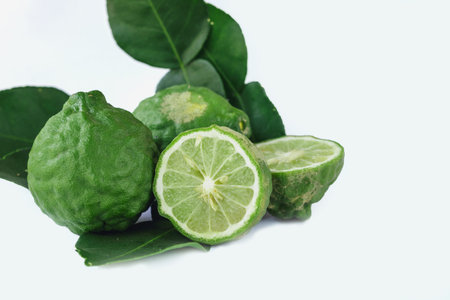 Bergamot fruit with half and leaves on white backgroundの写真素材