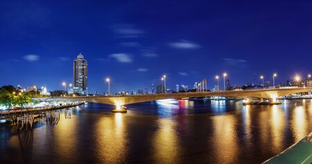 Panorama view of Bangkok cityscape at night time with bridge lightsの写真素材