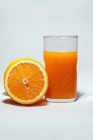 Fresh orange juice glass with fruitの写真素材