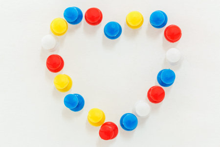 Concept, pins on  paper white the heart symbol.